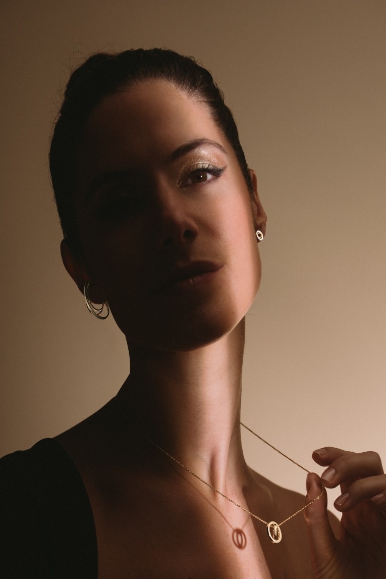 Woman showing her alba necklace